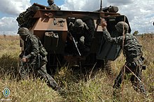 Soldiers disembarking from an EE-11 Urutu Cavalaria (29033875590).jpg