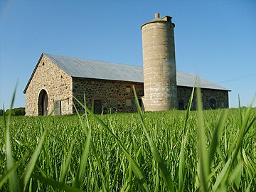 A stone barn built for cows in Wisconsin. The circular silo was used to store feed.