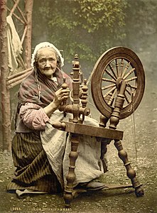 1890-1900 Elderly Irish woman at a spinning wheel.