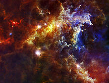 Composite infrared image (wavelengths: 250, 160, 70 microns) of part of the Rosette Nebula recorded by the Herschel Space Observatory. The bright patches are massive (~10 solar masses) protostars, the small spots are lower mass globules containing protostars Embryonic Stars in the Rosette Nebula.jpg