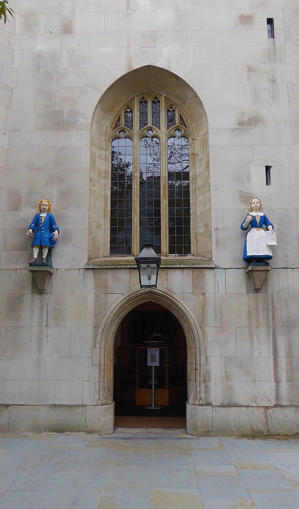 The same statues from the Foundling Hospital located in Hatton Garden are above the side door of St Andrew Holborn. Thomas Coram is buried here, his r