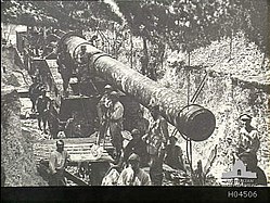 A French gun in a revetment and covered with camouflage netting at Glisy, France.