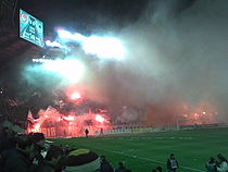 Olympiacos fans in Karaiskakis Stadium during a 3–2 derby win against rivals Panathinaikos.