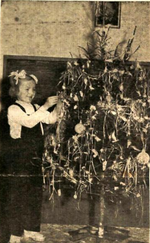 Girl from Kumanovo is decorating a Christmas tree. Girl and Christmas tree in Kumanovo 1962.png