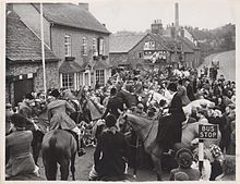 The village centre around 1920, The Stamford Arms, former home of the Everard family became a pub in 1921. According to Groby Heritage Group, the tall chimney belonged to a quarry. Hunt meeting outside Stamford Arms Groby.jpg