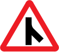 Skewed side road junction ahead to right