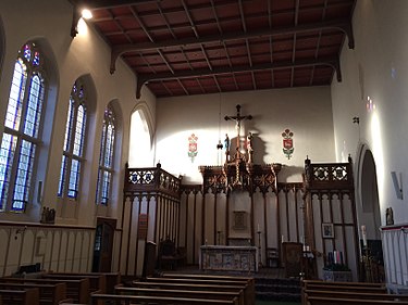 Interior of St Cuthbert's with the high altar and heraldic rood screen. Interior St. Cuthbert's Catholic Church, Durham.jpg