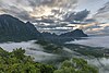 Karst mountains colorful clouds and mist at sunrise from the top of Mount Nam Xay Vang Vieng Laos.jpg