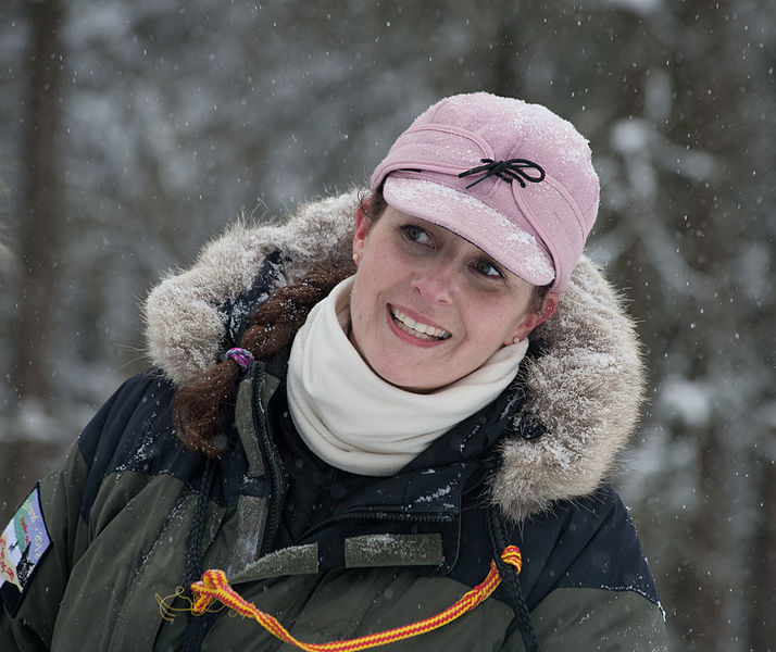 File:Lovely mush handler hitching a ride on a sled (6953080925).jpg