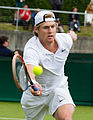 Luke Saville competing in the first round of the 2015 Wimbledon Qualifying Tournament at the Bank of England Sports Grounds in Roehampton, England. The winners of three rounds of competition qualify for the main draw of Wimbledon the following week.