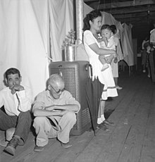 Typical barrack apartments with cloth partitions between units (June 30, 1942) Manzanar Relocation Center, Manzanar, California. A typical interior scene in one of the barrack ap . . . - NARA - 538136.jpg