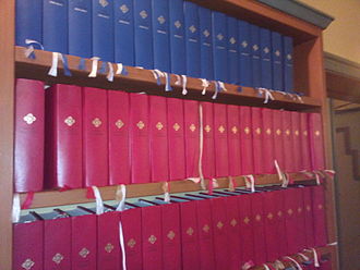 The 2013 Norwegian hymnal on a shelf at Meland Church. The red volumes are the standard edition and the blue ones are the large-print edition. Norsk salmebok 2013.jpeg