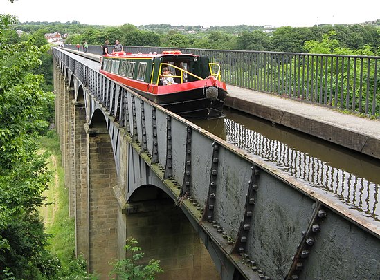 A canal boat traverses the longest and highest aqueduct in the UK, at Pontcysyllte in Denbighshire, Wales.