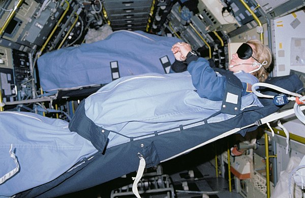 Mission Specialist Margaret Rhea Seddon, wearing a blindfold, sleeps in SLS-1 module (STS-40)