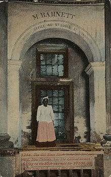 Divided-back era postcard: "The Old Slave Block in the Old St. Louis Hotel, New Orleans, La. The colored woman standing on the block was sold for $1500.00 on this same block when a little girl." St Louis Hotel Slave Block Sold as a Child Postcard.jpg