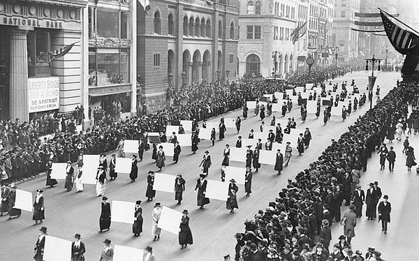 Women's suffragists parade in New York City in 1917, carrying placards with the signatures of more than a million women.