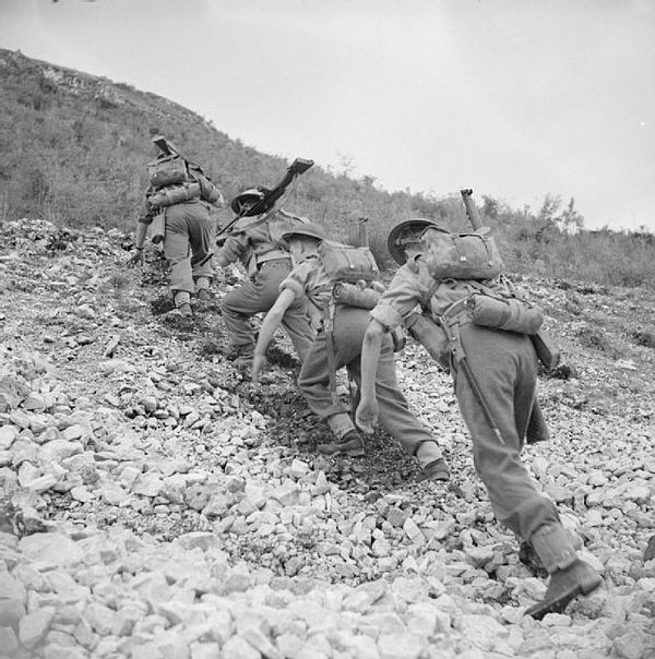 Men of the 1st Battalion, King's Own Yorkshire Light Infantry climb a steep hill in Italy, November 1943.