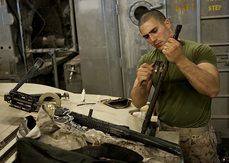 File:U.S. Marine Corps Lance Cpl. Vincent Russo, with the 24th Marine Expeditionary Unit (MEU), cleans an M240B medium machine gun aboard the amphibious transport dock ship USS New York (LPD 21) April 12, 2012, while 120412-N-XK513-032.jpg