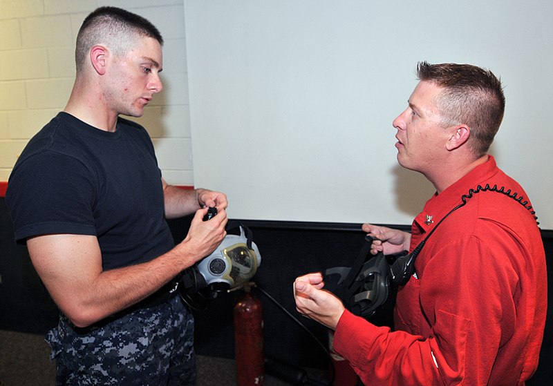 File:U.S. Navy Quartermaster 2nd Class Michael Wignall, right, instructs Seaman Recruit Stefan Berklacich how to properly wear the MCU-2P Gas Mask in the USS Chief (MCM 14) Fire Fighting trainer at Recruit Training 120629-N-IK959-433.jpg