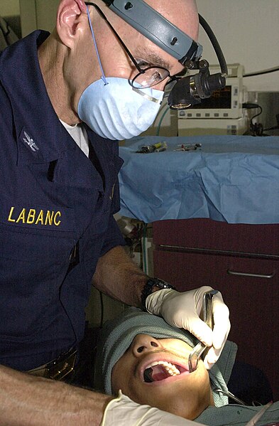 File:US Navy 030324-N-6536T-005 U.S. Navy Dentist Capt. John Labanc, from Hillsburrow, Ill., extracts a wisdom tooth.jpg