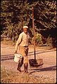 WORKMAN ON WAY TO CLEAN UP A POLLUTED CREEK - NARA - 545371.jpg