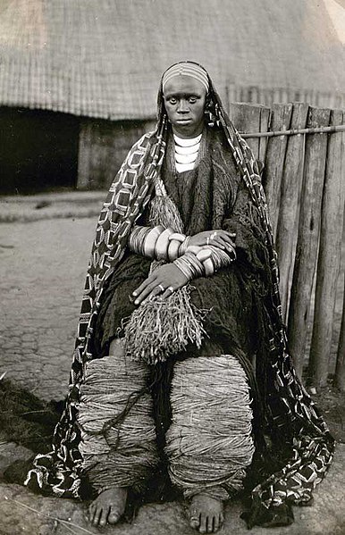 File:Well-of native woman sitting in front of a cottage, 1928. (9420074989).jpg