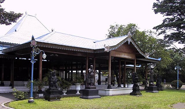 Brown wood pavilion with statues
