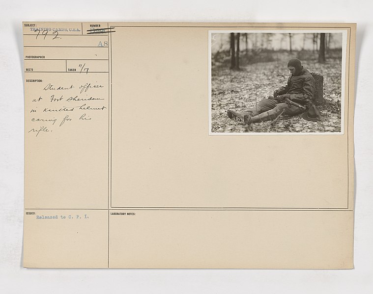 File:111-SC-792 - Student officer at Fort Sheridan in knitted helmet caring for his rifle - NARA - 55162913.jpg