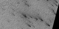 Close view of defrosting, as seen by HiRISE under HiWish program. Gas and dark dust is probably being blown out of ground and then carried by winds toward the Northwest.
