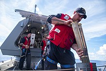 Sailors load ammunition aboard USS Gabrielle Giffords