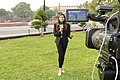 A student of Heritage Institute of Management & Communication, New Delhi is doing reporting from the outside of the Indian Parliament House.jpg