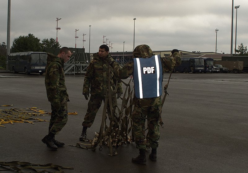 File:Airman 1st Class Jamal Avery, 86th Maintenance Squadron, Airman 1st Class Richard Washburn, 86th Transportation Squadron, and Airman 1st Class James Jackson, 86th Supply Squadron, prepare nets that will be used 020128-F-ZU221-002.jpg