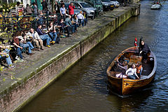 A family boat ride on a sunny sunday in the Herengracht. Amsterdam, The Netherlands