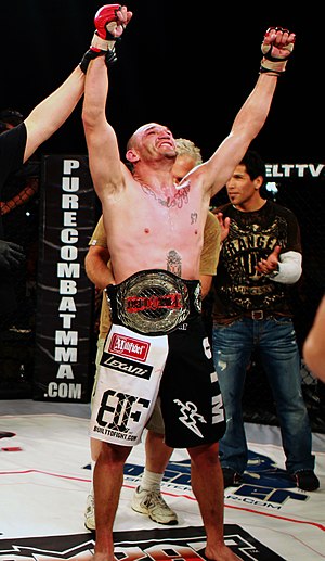 A mixed martial artist and his championship belt