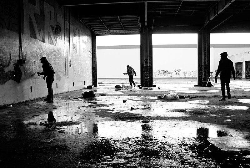 File:BW photograph of graffiti artists at work in a flooded abandoned garage 2009-12-12.jpg