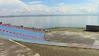 The left side of the Balyuan Park arena facing northeastward towards Cancabato Bay and the San Juanico Strait beyond, backgrounded by Samar island on the horizon.