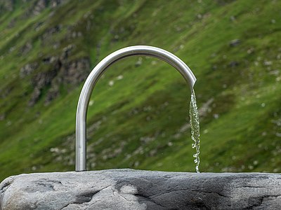 Drinking fountain at the Barbara Chapel above the Bielerhöhe mountain pass. Vorarlberg, Austria