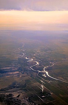 Aerial view from the north of the Colorado River on the Arizona–California border, showing the small Palo Verde Diversion Dam that diverts water to the west (right) into the main canal  to irrigate the Palo Verde Valley around Blythe.  Canals on the Arizona side (left) in the Parker Valley are also visible, in the foreground.