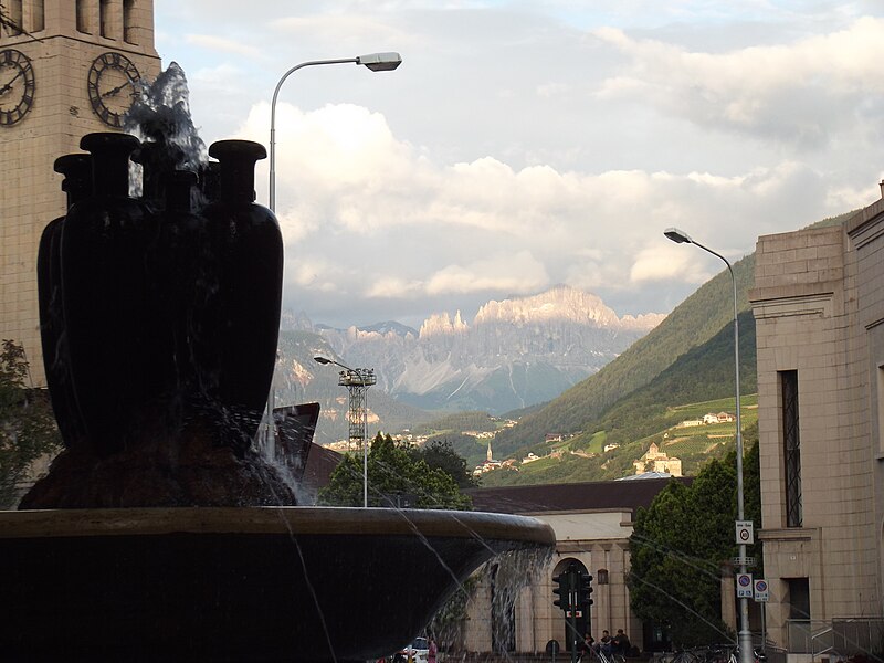 File:Dolomites seen from Bolzano and fountain.jpg