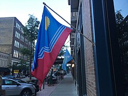 A flag of Sioux Falls flying in Downtown Sioux Falls, with a flag of South Dakota in the background Flag of Sioux Falls in Downtown Sioux Falls.jpg