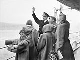 The Royal Family of Norway waving to the welcoming crowds from HMS Norfolk at Oslo, June 1945