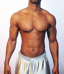 An adult man with a "V-shaped body"; pronounced shoulder width and expanded chest, both traits typically associated with male physique Half-naked male.jpg