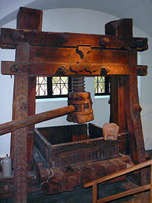 Early modern wine press. Such screw presses, used in Europe for a wide range of uses, provided Gutenberg with the model for his printing press. Holzspindelkelter von 1702.jpg