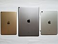 The backs of a gold Apple iPad 5, a space gray iPad Pro 12.9″, and a silver iPad Pro 11″