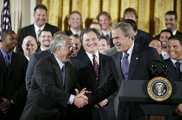 Shaking hands with manager Jack McKeon, President George W. Bush hosts a visit by the 2003 World Series Champions, the Florida Marlins, to the White H