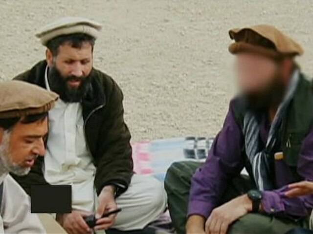 CIA team deputy chief (right) meeting with Afghan mercenaries in Tora Bora, 2001