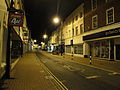 The High Street, Newport, Isle of Wight viewed from the traffic lights at the cross roads in the middle at night.