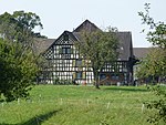 Half-timbered farmhouse with barn and stable