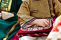 Quran bag was embroidered by bride with gold threads with traditional ornament ornek in little boy's hands