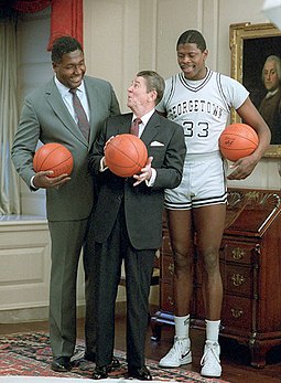 Georgetown coach John Thompson (left) managed to sign high-school basketball standout Patrick Ewing (right). Here, both pictured with President Ronald Reagan in November 1984 Ronald Reagan with John Thompson, Patrick Ewing (cropped).jpg